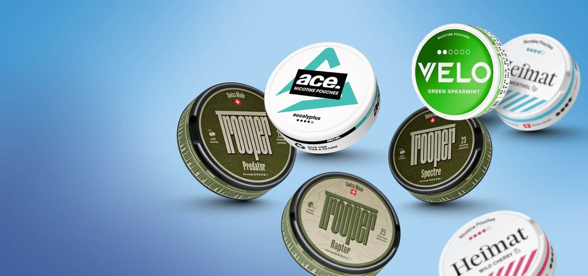 Επιλογή snus και σακουλάκια νικοτίνης: Nоoper, Velo Green Spearmint και κουτιά Heimat σε μπλε φόντο